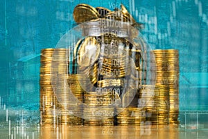 Double exposure of coin stack with stock market screen chart boa