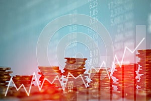 Double exposure of coin stack with stock market screen chart boa