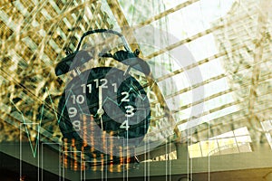 Double exposure of coins stack with alarm clock background and finance graph for business and financial concept