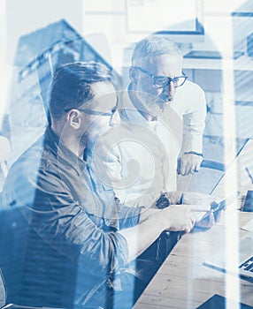 Double exposure concept.Team of business people making great work discussion in studio.Young bearded man showing mobile