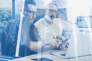 Double exposure concept.Team of business people making great work discussion in studio.Young bearded man showing mobile