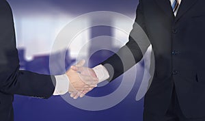 Double exposure of confident Asian businessman shaking hand in m