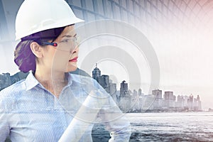 Double Exposure of Construction Engineer Woman in Safety Equipment on Cityscape Background, Smart Business Woman With City