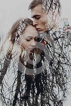 Double exposure with couple and tree branches in autumn park. se