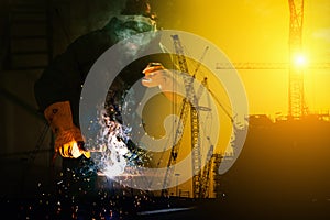 Double Exposure of Craftsman Welder is Welding Steel Frame on Construction Site Background, Welder Man in Safety Protective