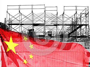 Double exposure creative hologram of unfinished supertall building and Chinese flag. Describe China\'s real estate collapse