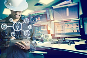 Double exposure of Engineer or Technician man with business industrial tool icons while using tablet with monitor of computers