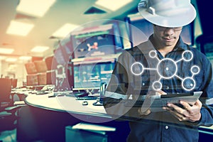 Double exposure of Engineer or Technician man with business industrial tool icons while using tablet with monitor of computers