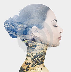 Double exposure of female face and rocky landscape