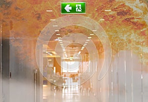 double exposure green emergency exit sign in hospital showing th