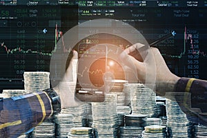 Double exposure of Hand holding blank smart phone checking financial stats on screen with group of coins and stock background for