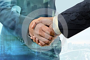 Double exposure of handshake between businessman with cityscape and EURO money - Business concept