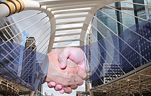 Double exposure of handshake and city.handshake and business people concepts.