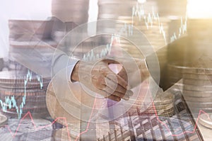 Double exposure handshake with stock graph and coin money.