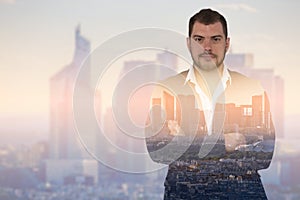 Double exposure image of businessman on cityscape background