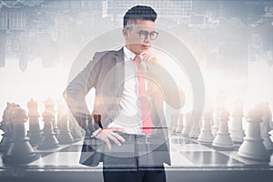 The double exposure image of the businessman thinking overlay with chess game image and white copy space. the concept of strategic