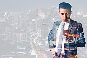 The double exposure image of the businessman using a smartphone and overlay with cityscape image. the concept of 5G, smartphones,