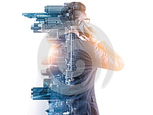 The double exposure image of the businessman using a smartphone during sunrise overlay with cityscape image. photo