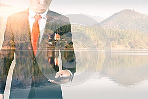 The double exposure image of the businessman using a smartphone during sunrise overlay with nature image. The concept of telecommu