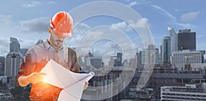 Double exposure image of construction engineer manager workers in orange hardhat and looking layout plan standing during overlay