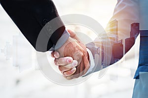 Double exposure image of investor business man handshake with partner