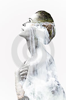 Double exposure image of a woman portrait with a waterfall landscape