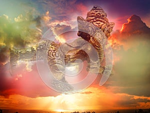 Double exposure with Lord Ganesha and colorful sunset sky background