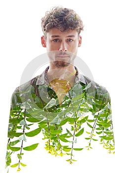 A double exposure male portrait merged with green shoots at the bottom