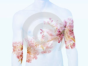 Double exposure of male torso and cherry blossom