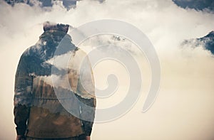 Double Exposure of Man and Cloudy Mountains forest