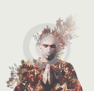 Double exposure man prayes. Autumn forest around. Concept of peace, appeasement, yoga, mantra, meditation