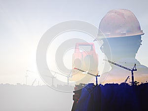 Double exposure man survey and civil engineer stand on ground working in a land building site over Blurred construction worker on