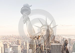 Double exposure of Manhattan skyline in new york city with statue of liberty silhouette