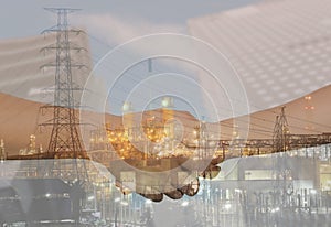 Double Exposure of Oil refineries and business handshakes join h photo