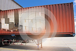 Double Exposure of Package Boxes Inside Shipping Container. Trailer Trucks Parked Loading at Dock Warehouse.