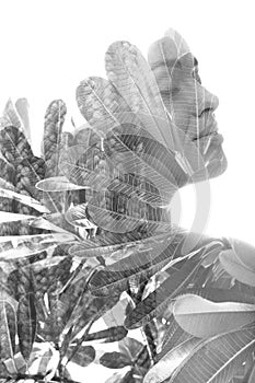 A double exposure portrait of a female model combined with an image of leaves