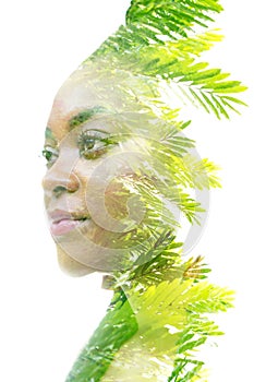 A double exposure portrait of a woman combined with an image of a plant. Dreaming about nature.