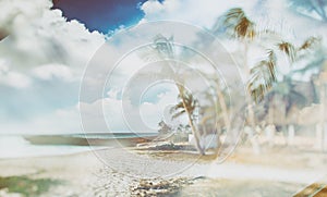 Double exposure of retro style background on which there is the beach with palm trees