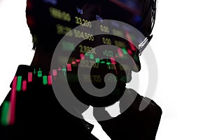 Double Exposure Silhouette of thinking businessman with stock market pricelist.