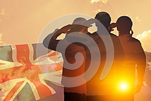 Double exposure of Silhouettes of soliders and the sunset or the sunrise against Australia flag. Anzac Day.