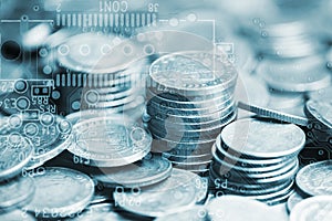 Double exposure of stack of coins and graphics card with graph for business finance