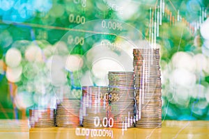 Double exposure of stacks of coins with stock exchange price of