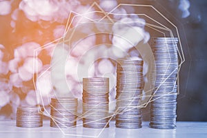 Double exposure of stacks of coins on the table in garden with f