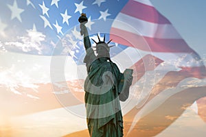 Double exposure with statue of liberty and United States flag blowing in the wind