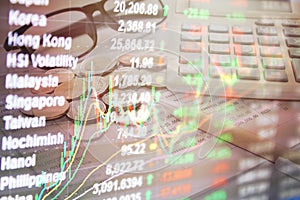 Double exposure of stock exchange market graph chart and stocks data on monitor on money and saving account passbook background