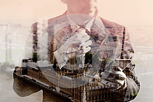 double exposure of success businessman holding tie and using smart phone,thinking,front view,filter effect,London buildings city