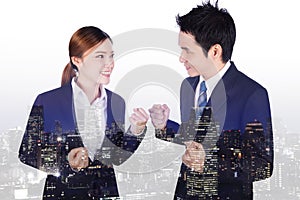 Double exposure of successful business man and woman with arm ra