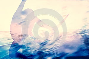 Double exposure of a surfer surfing in the ocean.