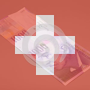 Double exposure of Swiss flag with Swiss one thousand Franc notes