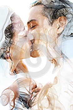 Double exposure of two blissful people with wet black hair embrace